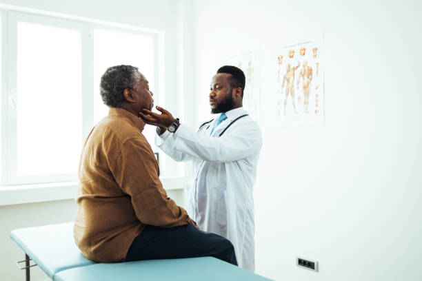istock Senior man with throat infection visiting a doctor 1412852052
