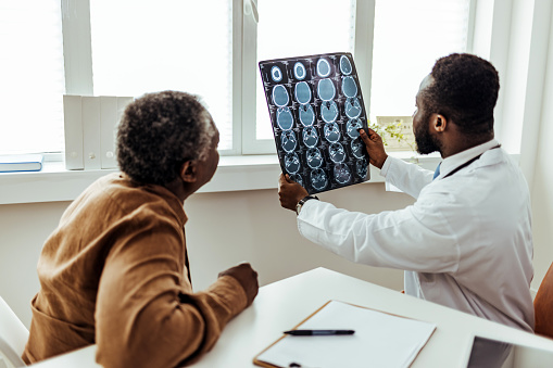 Male Doctor and Patient Examining brain MR