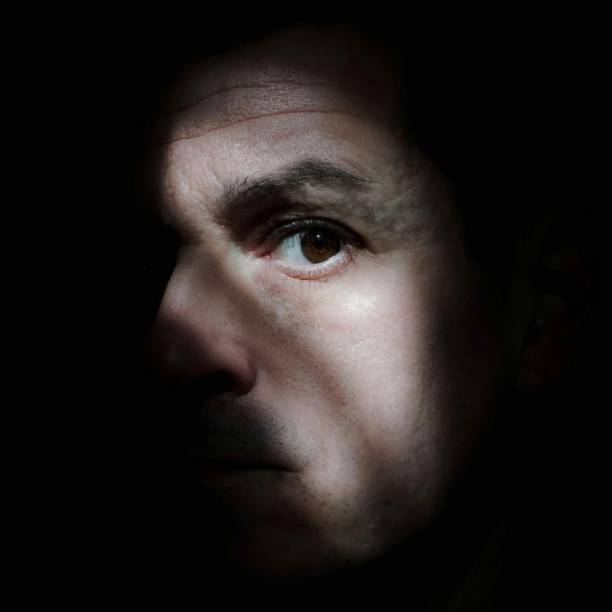 spanish man taking a selfie portrait in the shadows, caucasian man, 40 yo
