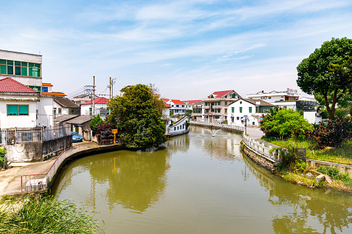 Wenzhou, China - June 26, 2022: A river flows through a residential district full of houses. There are no people in the scene.