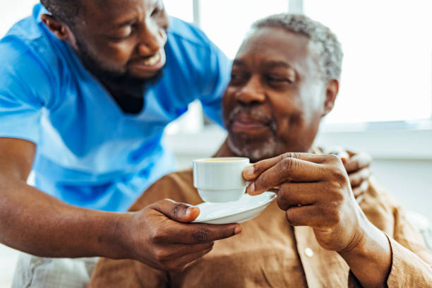 istock Nurse assist elderly senior man at nursing home 1412852674