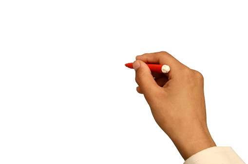 Cut out of One human male hand with white color shirt sleeve holding a red colored sketch pen and pointing and isolated over white background. There is text no people and ample copy space