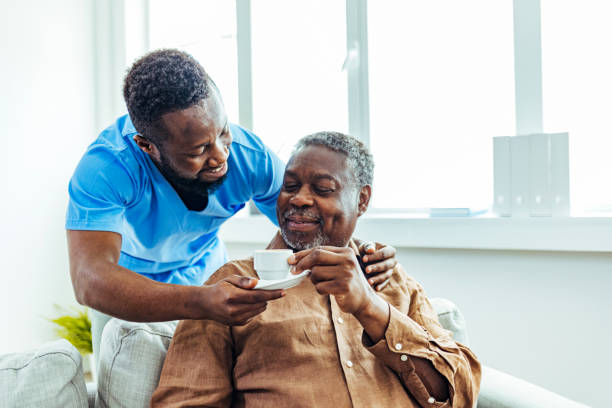istock Young nurse checking up on a senior man at a nursing home 1412852709