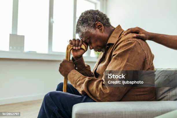 Senior Man Being Cared For By A Young Nurse In A Retirement Home Stock Photo - Download Image Now