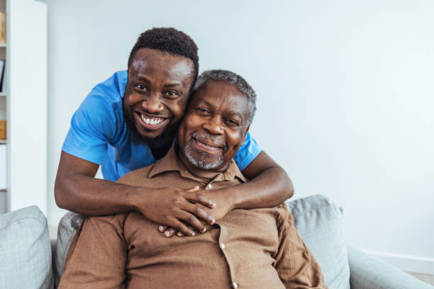 portrait of senior man and his mixed race male caregiver - male nurse black nurse doctor imagens e fotografias de stock