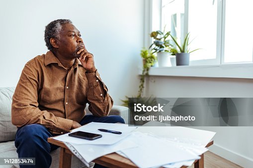 istock Mature businessman looking out of window 1412853474