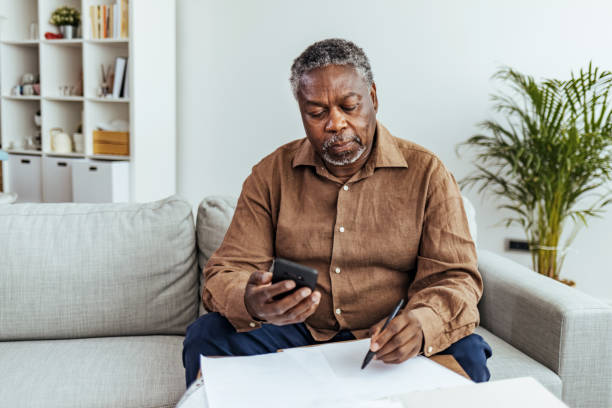 istock Senior man looking at smartphone at home 1412853580