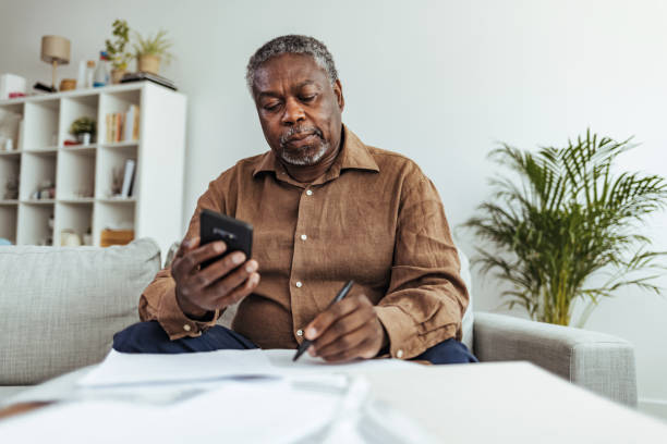 istock Mature businessman working at home using smart phone 1412853615