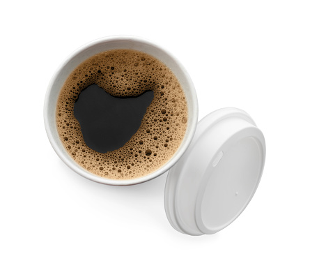 Aromatic coffee in takeaway paper cup and lid on white background, top view