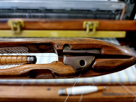 Antique Wooden Boat Loom Shuttle as part of a Loom making cotton textiles.