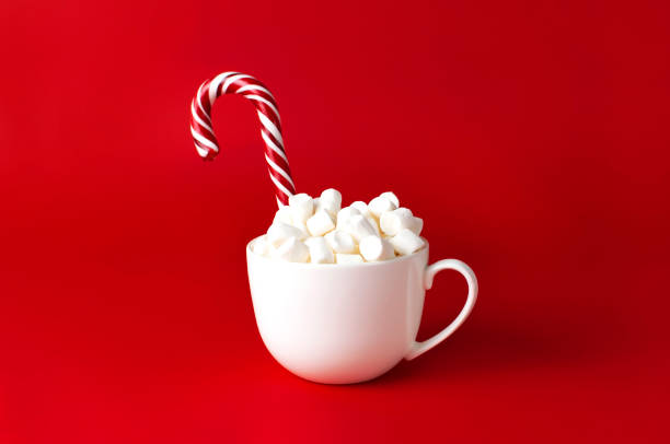 istock Christmas New Year drink, white mug with marshmallows and Candy Cane on red background Flat Lay copy space. Winter traditional drink food. Festive decor, celebration Xmas holiday 2019 1412856181
