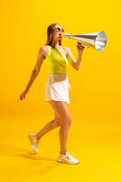 istock Excited young girl, student going with big retro megaphone isolated on bright yellow background. Concept of fashion, emotions and facial expressions 1412857049