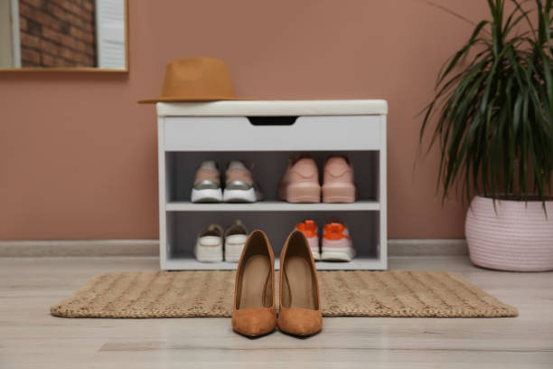 istock Shelving unit and stylish shoes on floor in hall 1412858488