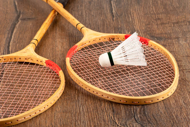 istock Plastic shuttlecock on one of two badminton rackets. 1412858605