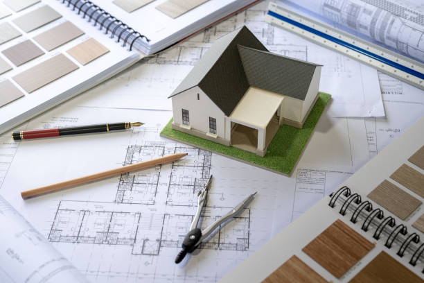 Architect Design Concept, House model on Buleprint construction drawing and drawing equipment stationary