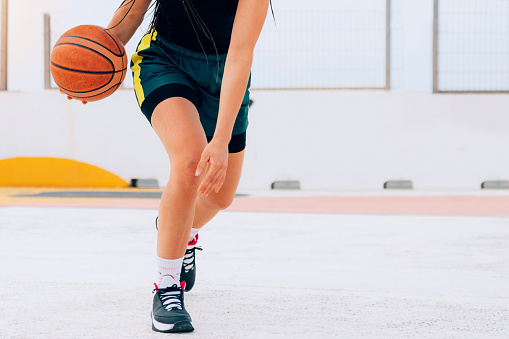 Athlete person playing basketball on a street court. Lifestyle, sport and wellness