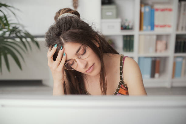 istock Tired young woman with headache 1412859874