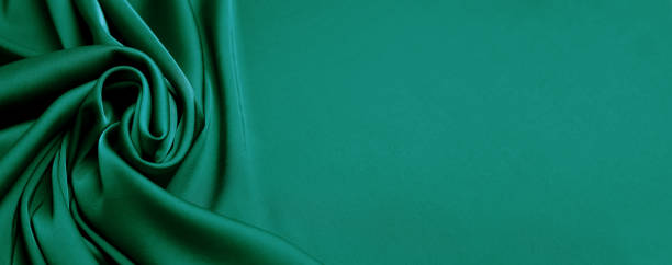 istock Green silk fabric as background, top view with space for text. Banner design 1412859952