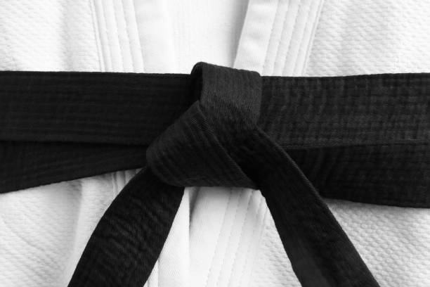 istock Martial arts uniform with black belt, closeup 1412860288
