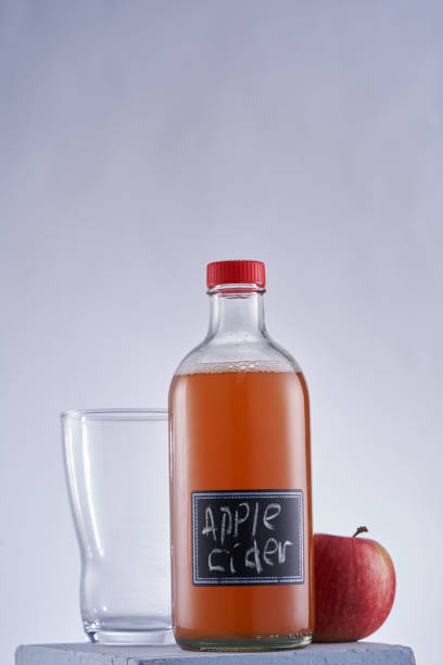 istock Close up  bottle of apple cider vinegar and fresh apple 1412860500