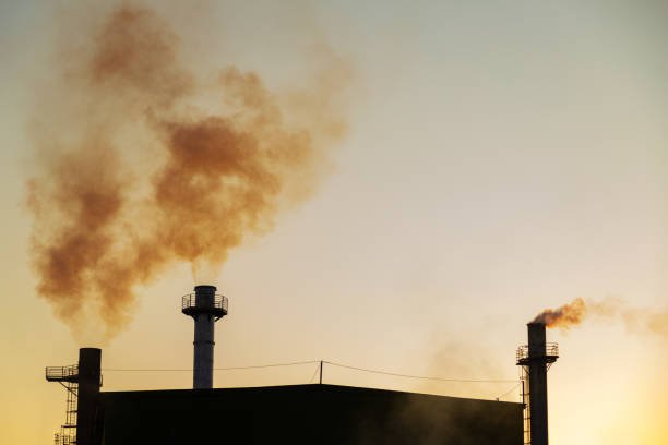 istock Factory smoke polluting the air. 1412865557