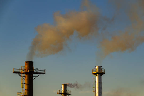 istock Factory smoke polluting the air. 1412865680
