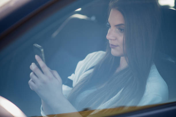 istock Young woman sitting in the car 1412866769