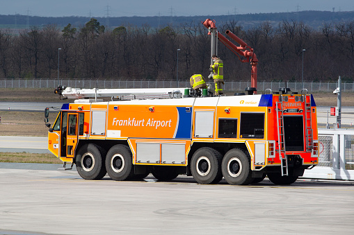 Frankfurt, Germany - April 06, 2022: An airport crash tender is being refilled with water during a fire drill at Fire Training Center nearby Fire station 3 at Frankfurt Airport.