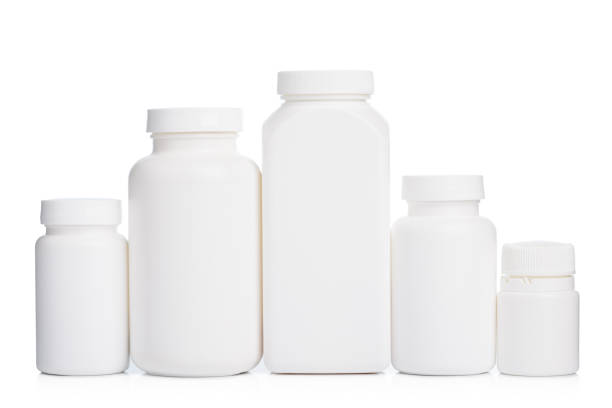 istock Blank plastic bottles with supplements or medication in a row isolated on white 1412869263
