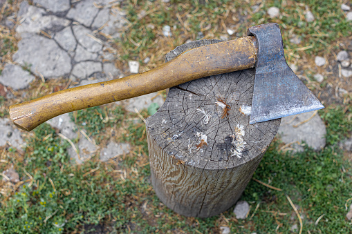 an ax with a wooden handle lies on a wooden block. High quality photo