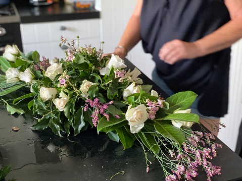Woman makes a mourning bouquet as remembrance
