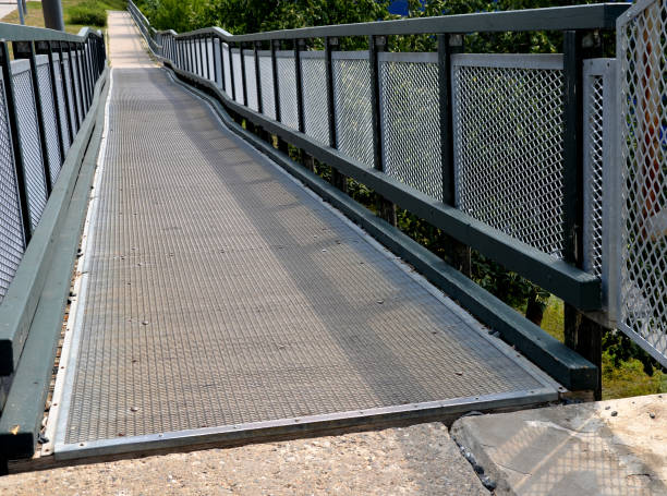 istock access ramp for disabled and wheelchair users. the elevation is spread over the long length of the pedestrian bridge. replaces the staircase 1412873912