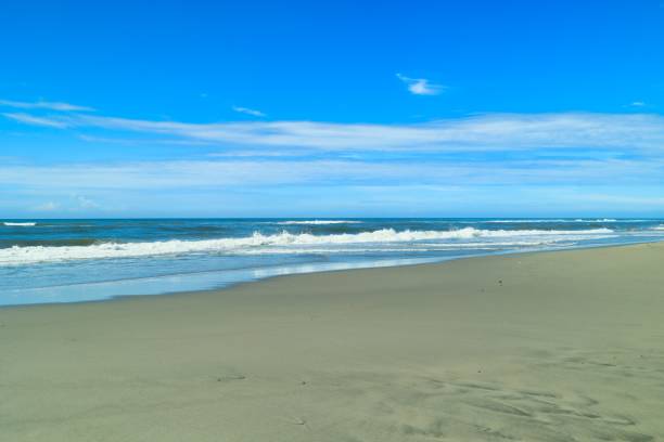 istock Pacific waves and sandy beach with blue sky in the early morning 1412873978