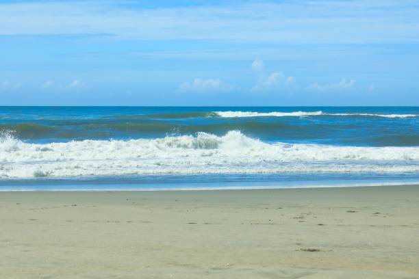 istock Pacific waves and sandy beach with blue sky in the early morning 1412874022