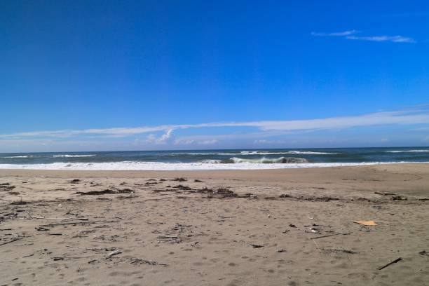 istock Pacific waves and sandy beach with blue sky in the early morning 1412874036