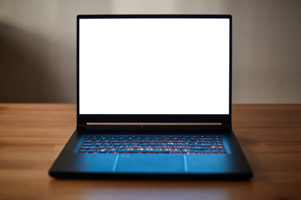 istock Laptop or notebook with blank screen on wood table. Clipping path. 1412875329