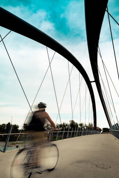 istock George C. King Bridge and a motion-blurred biker over Bow River and St. Patrick's Island Park in Calgary on a dramatic cloudy early morning 1412875479