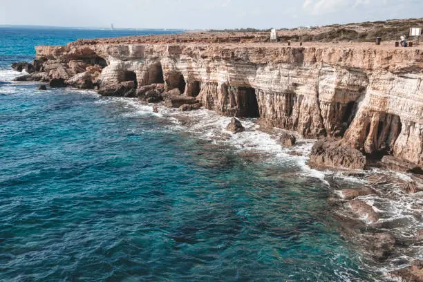 Photo of Beautiful sea caves near cape Greco in national park with turquoise water