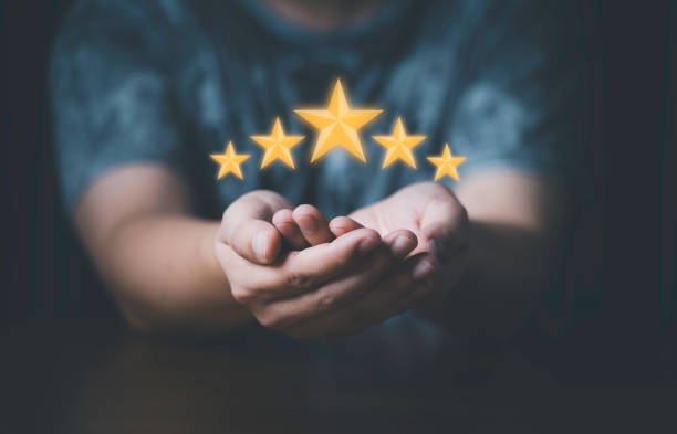 istock Businessman showing glowing yellow five stars for excellent evaluate after customer use product service , ISO and quality standard certificate concept. 1412879771