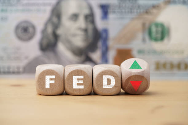 istock FED print screen on wooden cube block with up down arrow and US dollar banknote background for interest rate increase and decrease   concept. 1412879831