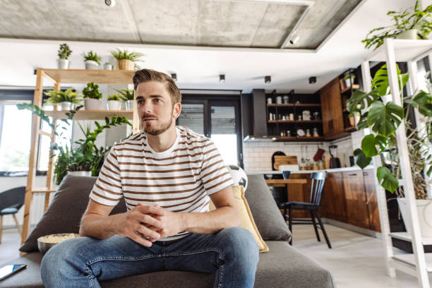 istock Young man concentrating while watching sport match on TV 1412880111