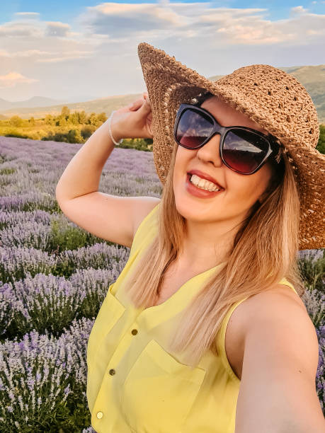 istock Young Woman Taking A Selfie In Lavender Field 1412880637