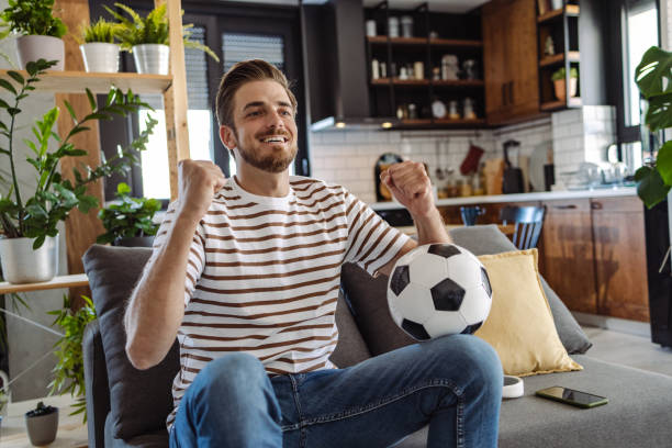 istock Soccer fan celebrating during match 1412880689
