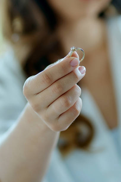 istock Heartbroken woman returning the engagement ring 1412883585