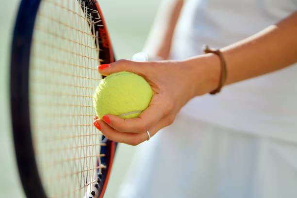 istock Tennis player's hand preparing to take a serve 1412883675