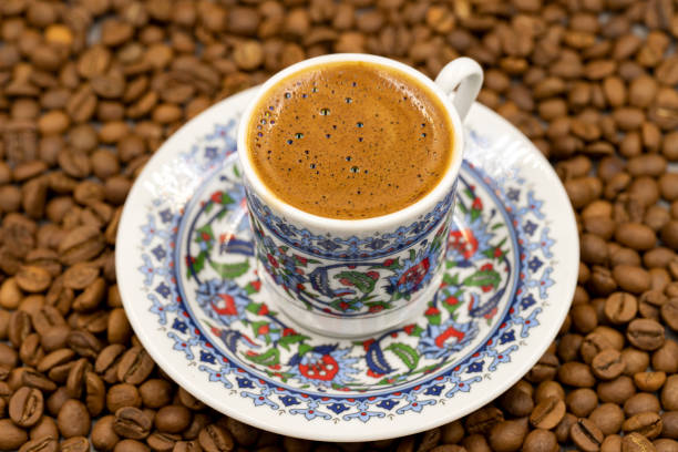 istock Turkish coffee in a classic coffee cup. Coffee beans background. close up 1412884436