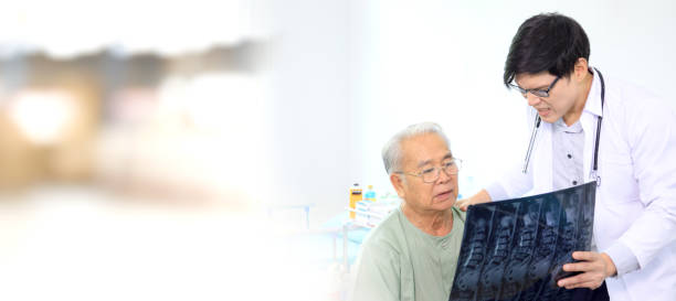 Doctor explaining a medication treatment. Asian elder adult having a consult with doctor about his disease, doctor explains the x-ray film to Asian senior adult. Health care and wellness in aging society. x ray results stock pictures, royalty-free photos & images