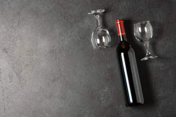istock Red wine in a bottle. Black concrete background. Flat lay. Copy space. 1412887701