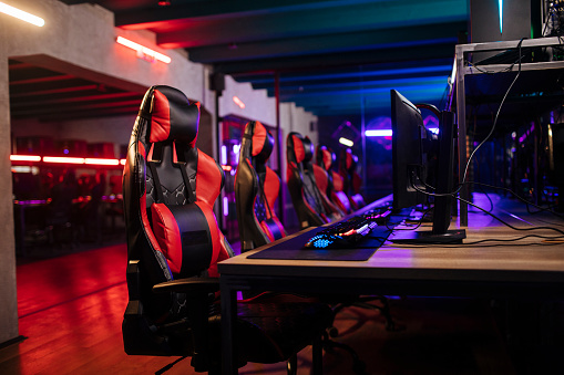 Photo of gaming chairs and computers in a cybersports arena