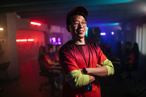 Chinese professional gamer poses while standing with his hands crossed